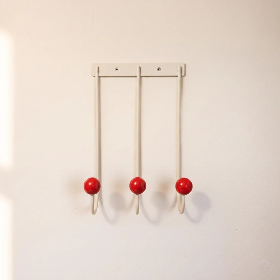 Sphere Hook Trio in White — cream 3-hook wall rack with red wood ball tips