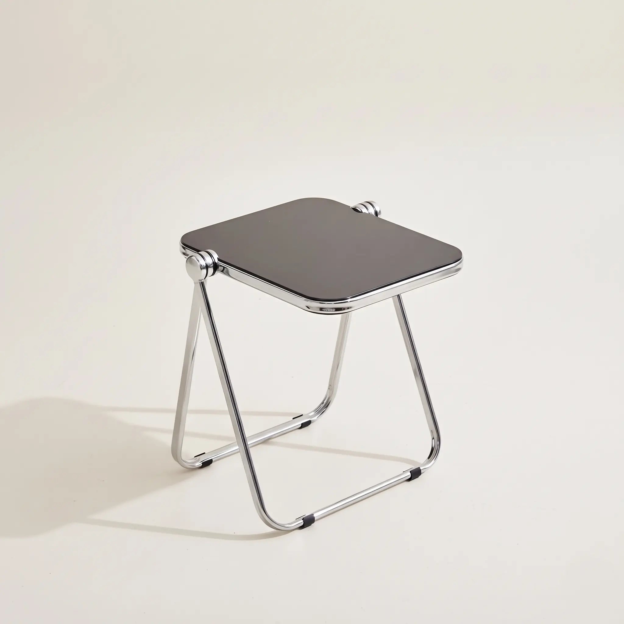 Lucent Tray Table in Black — opaque glossy black acrylic top, chrome A-frame folding base