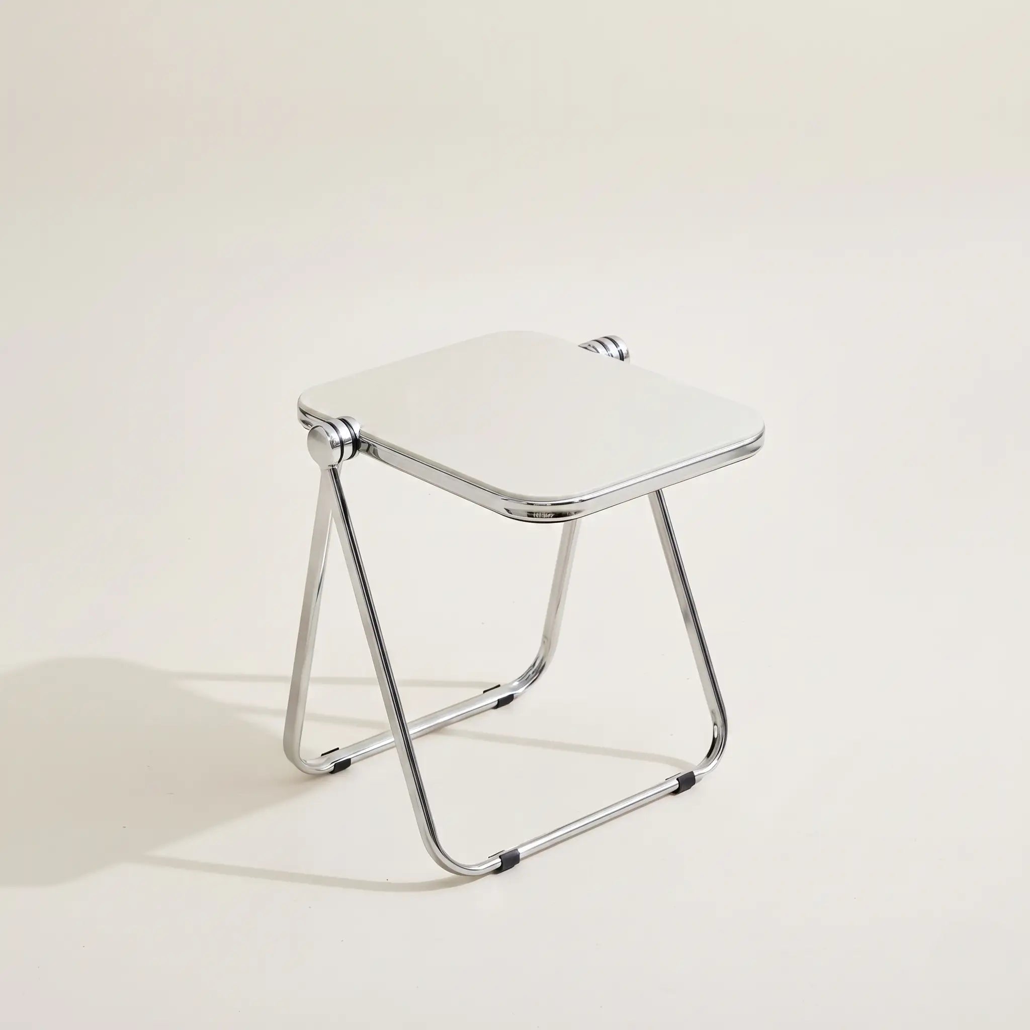 Lucent Tray Table in White — opaque off-white acrylic top, chrome A-frame folding base
