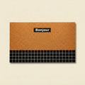 Orange Bonjour doormat in retro geometric PVC