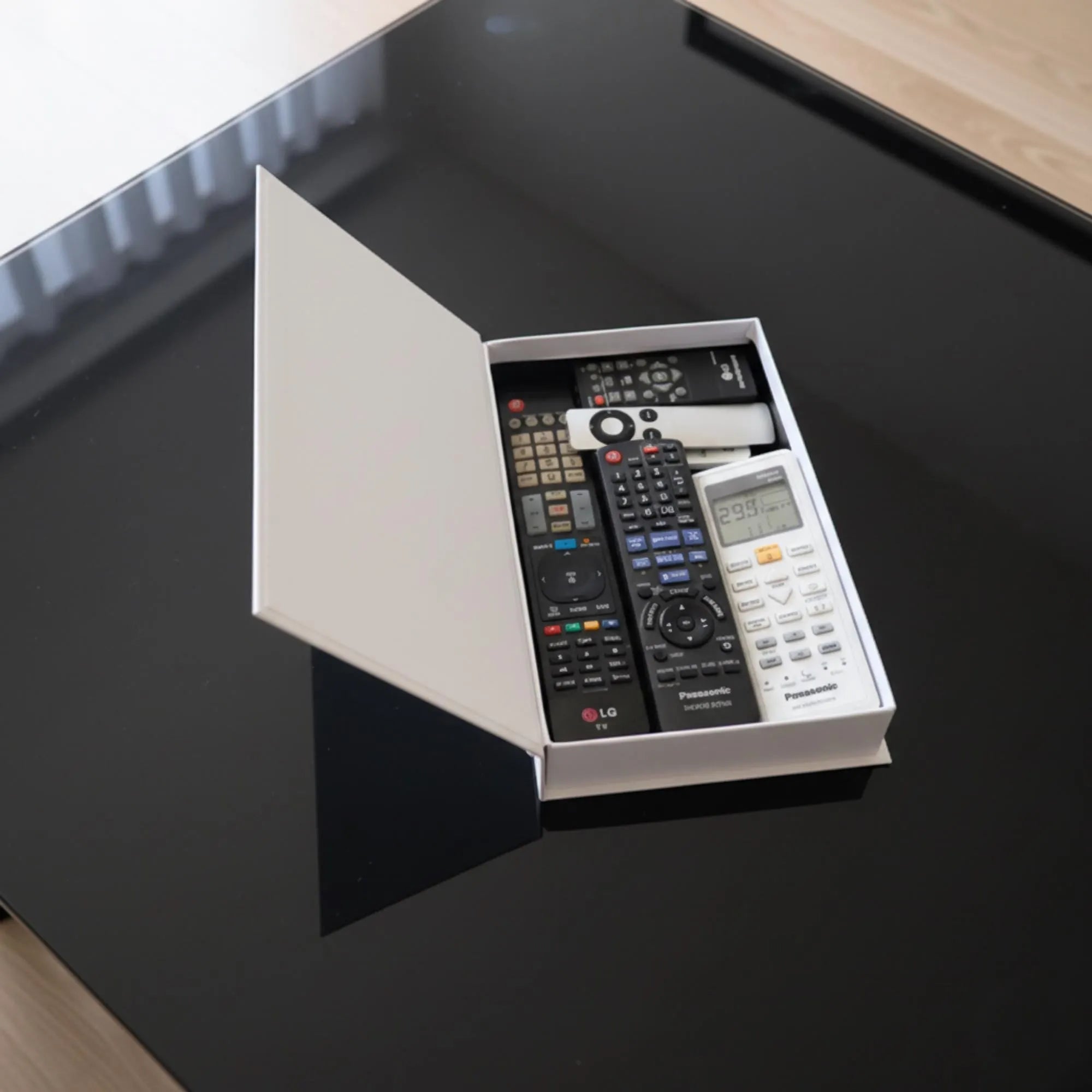 Faux book box opened, holding remote controls