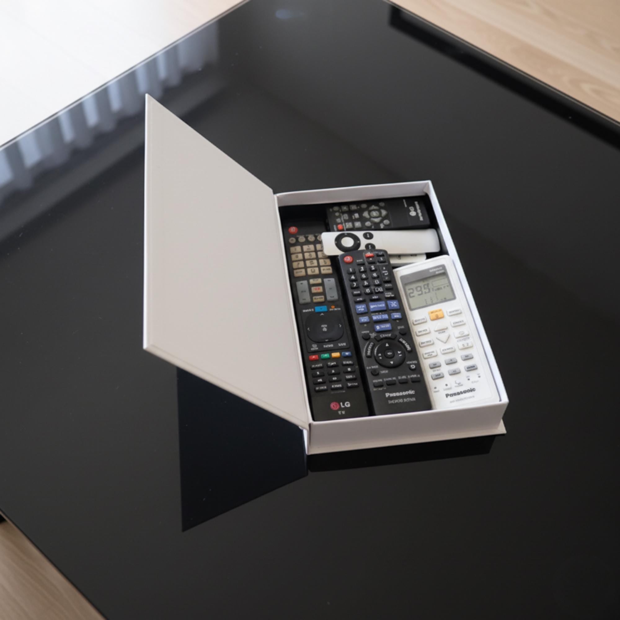 Faux book box opened, holding remote controls