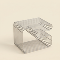 Linea Side Table in stainless steel wire styled in a living room corner