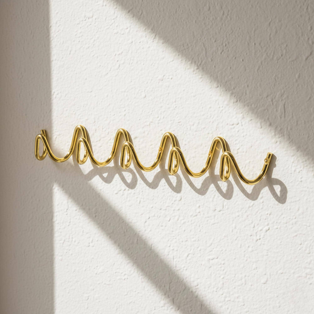 Wave Hook Rail — angled lifestyle shot, coat rack on a lightly textured wall